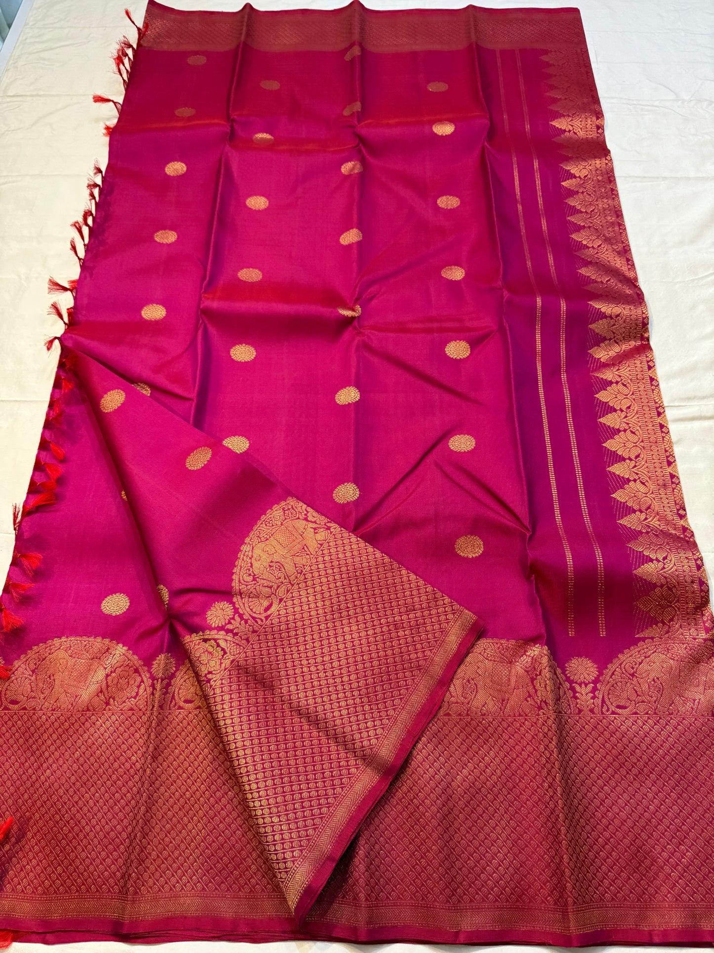 Rosette Bloom — Pure Kanchipuram Silk Saree
Vibrant rani-pink body with copper-rose zari buttas, elephant motifs & floral borders
Silk Mark Certified • Blouse Stitching ($30) • Free Shipping within USA • Ships in Two Weeks