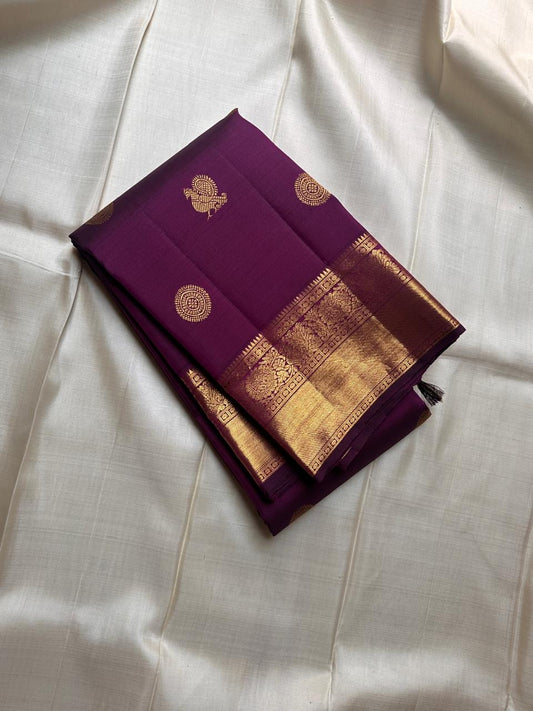 A silk symphony in the deepest shade of plum.mayil chakram butta bavanji border - classic in a stunning color plum pure silk Kanchipuram saree