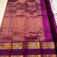 Mauve Mayil Mukham — Kanchipuram Pure Silk

Pastel-mauve pink  body with delicate zari wide kattam checks

Deep plum korvai border with grand mayil (peacock) chakram motifs

Copper-rose chevron zari pallu & plum contrast blouse

Silk Mark Certified • Free