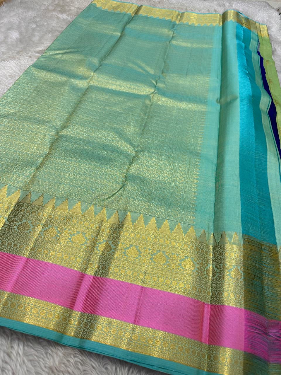 Rose pistachio meadow  – Pure Silk Kanchipuram Saree
Pista Green Body with Coin Paving Mayil Zari Buttas 🦚
Borders in Aqua & Rose with Pillayar Moggu Motifs ✨
Grand Aqua Pallu in All-Over Zari Brocade Weave
Silk Mark Certified | ships in 2 weeks