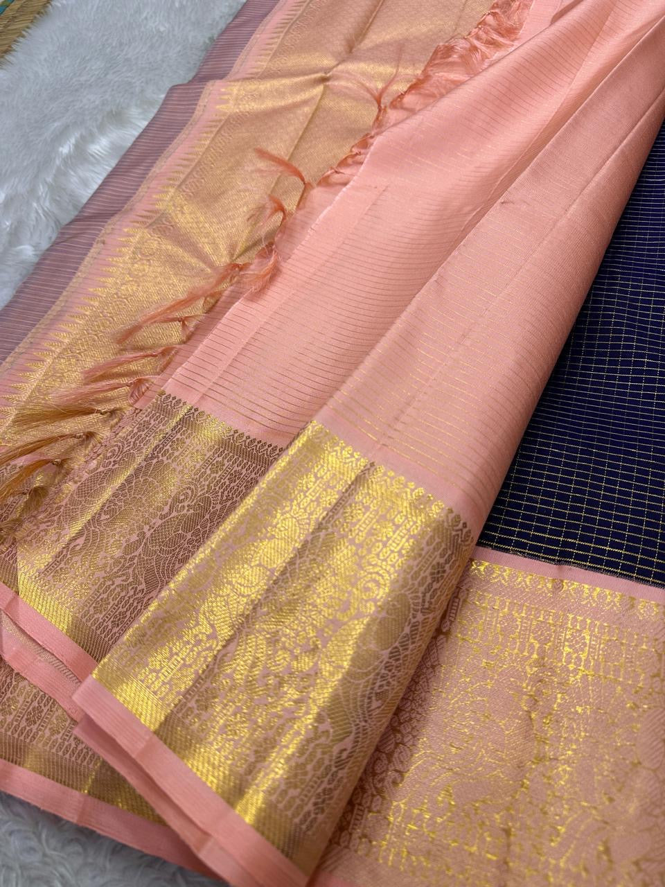 Deep navy blue Zari kattam with pink peach border peacock motif and Pallu