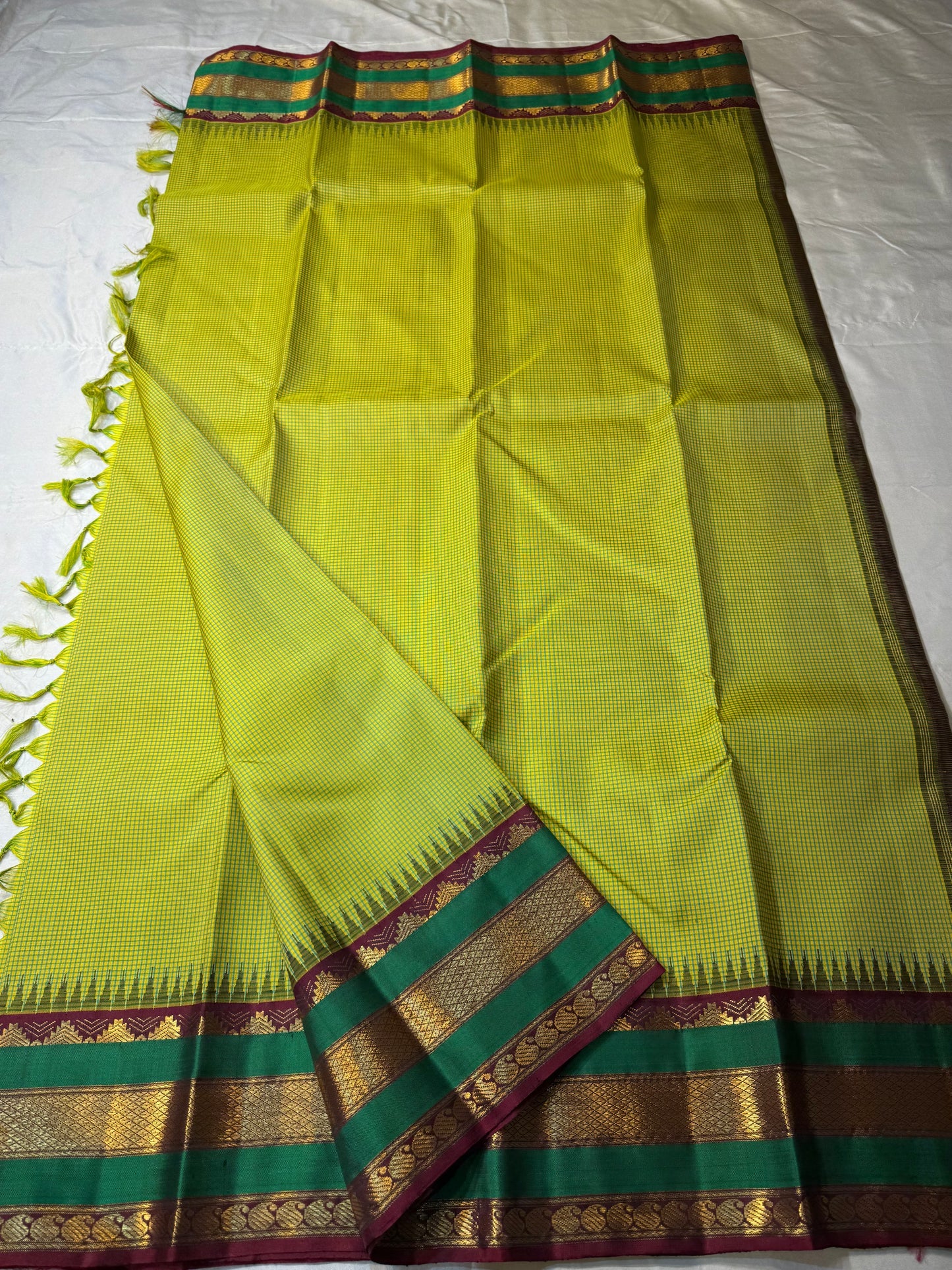 Gita  
Pure Silk Kanchipuram Saree  
Sampanga & Pea Green Podi Kattam  
Arakku Border with Triple Zari Bands