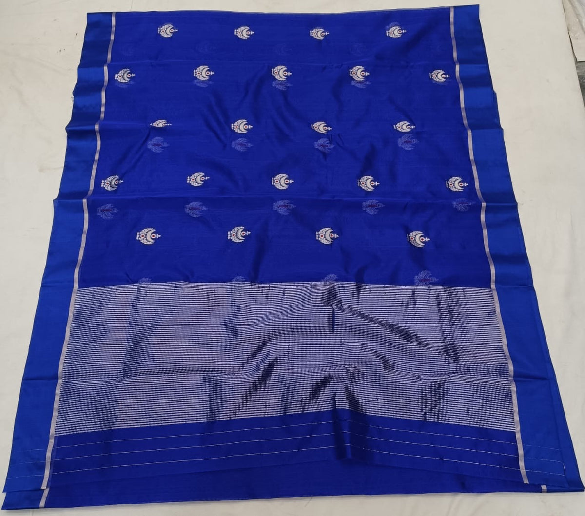 Detail of the Pattu Silk fabric and silver-toned ornamental motifs on a Royal Blue Chanderi saree