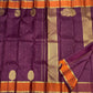 Ornate Mughal-inspired floral medallions on an aubergine Kanjivaram silk saree