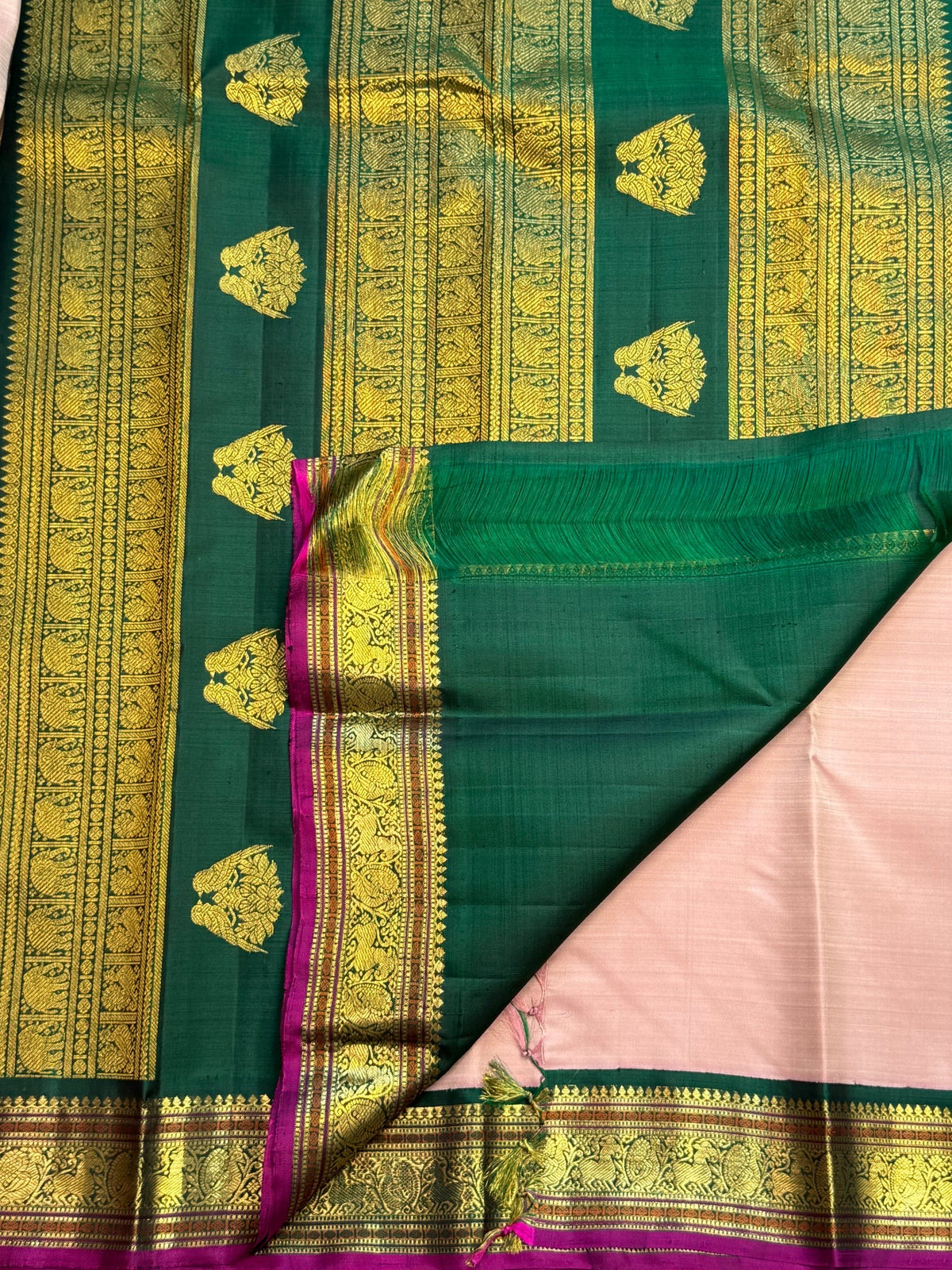 Full body view of petal pink pure silk Kanchipuram saree with Gandaberunda zari buttas