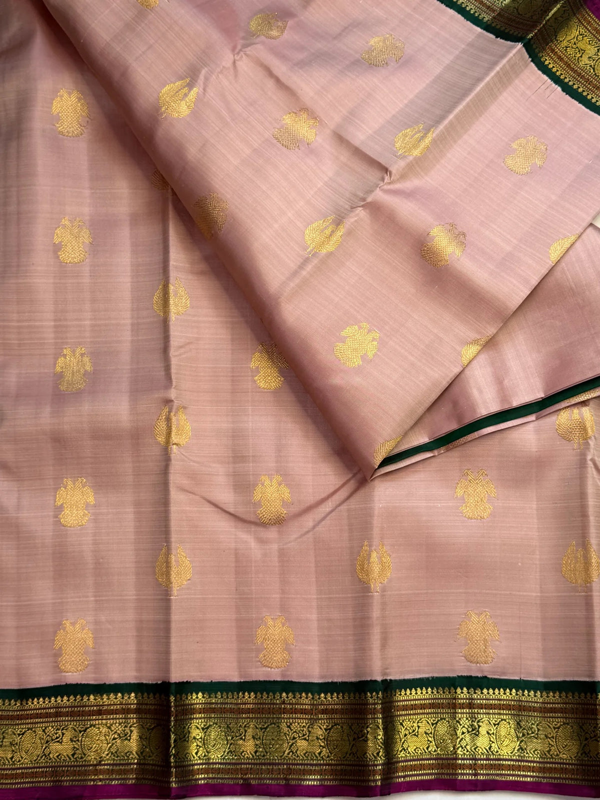 Rich emerald green pallu with twin-bird Gandaberunda zari motifs on a handwoven Kanchipuram saree