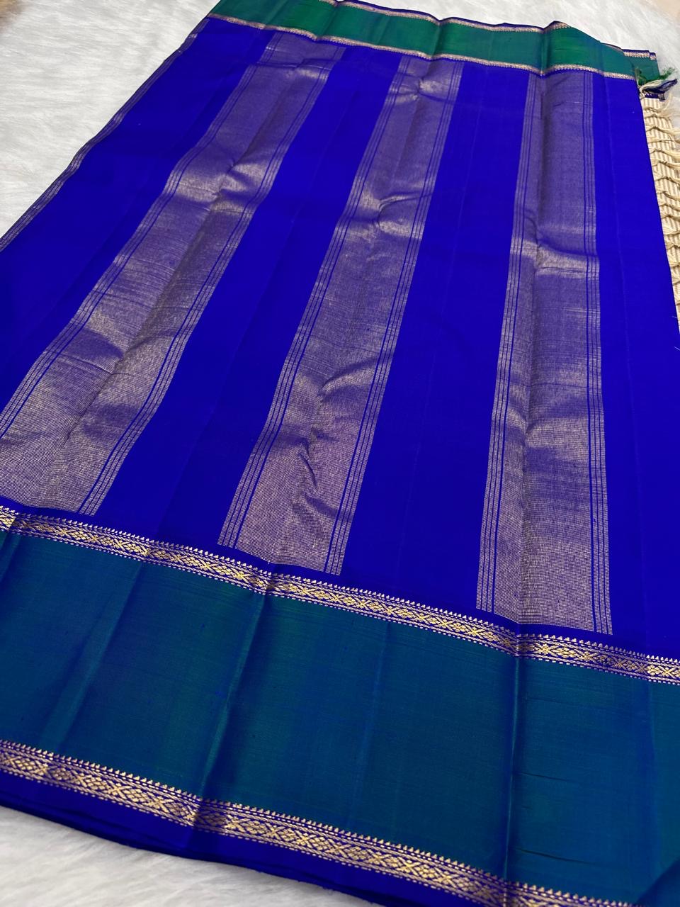 Ivory and Peacock Blue Handwoven Pure Silk Kanchipuram Saree with Kanchi Kattam Body and Rettapet Border
