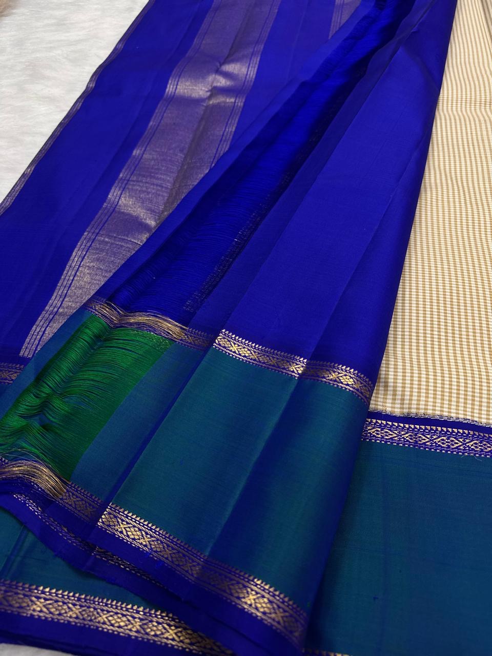 Ivory and Peacock Blue Handwoven Pure Silk Kanchipuram Saree with Kanchi Kattam Body and Rettapet Border