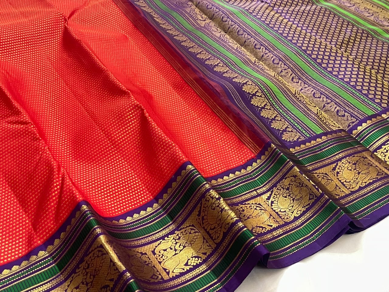 Deep purple and forest green silk thread woven border with Mayil and Yazhi Butta in antique gold zari — Kancheepuram saree detail