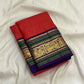 Full folded view of Kancheepuram Butta saree showing dense red gold butta body and purple-green border
