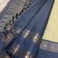 Folded view of the handwoven pale gold and steel blue Kancheepuram pure silk saree showing Teardrop Butta body and Rettapet Yaanai border