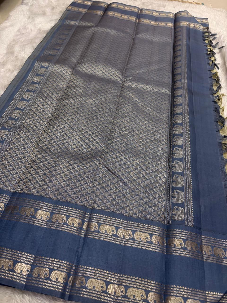 Pallu of the Kancheepuram saree in steel blue with Rettapet Yaanai procession and geometric gold zari banding