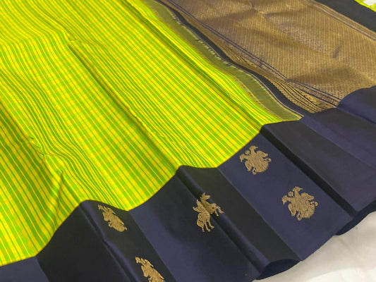 Lime green and navy blue handwoven pure silk Kanjeevaram saree with Gandaberunda Kudhirai butta border — full folded overview