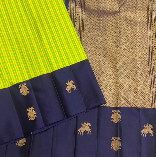 Gandaberunda and Kudhirai flying horse gold zari buttas on navy border of lime green Kanjeevaram saree — border detail