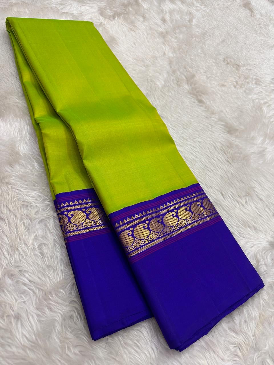Lime green and violet handwoven pure silk Kancheepuram saree with Korvai Kaal Irangiya Peacock border — full folded overview