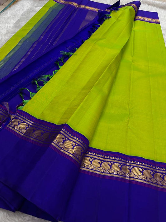 Close-up of vivid lime green pure silk body on handwoven Kancheepuram saree — high-lustre plain weave with electric fresh colour