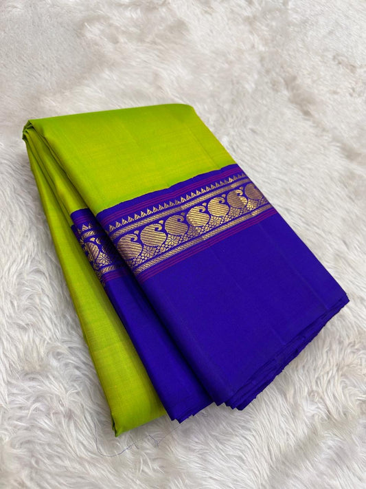 Pallu detail of lime green and violet pure silk Kancheepuram saree showing antique gold zari Mayil peacock motifs in Kaal Irangiya border