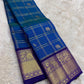 Peacock blue and violet handwoven pure silk Kancheepuram saree full view — shot colour Zari Kattam body with Yaanai Maanga buttas and deep violet antique gold zari border, Idam Living