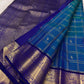Close-up of shot colour peacock blue-green silk body with Zari Kattam grid and Yaanai elephant and Maanga mango buttas in antique gold zari — handwoven Kancheepuram silk