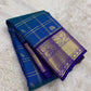 Pallu of peacock blue and violet Kancheepuram silk saree — grand antique gold zari Yaanai motifs on deep violet ground with layered zari band detailing