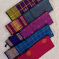 Folded peacock blue and violet pure silk Kancheepuram saree showing shot colour body and violet Yaanai border — handwoven heirloom silk, Silk Mark certified
