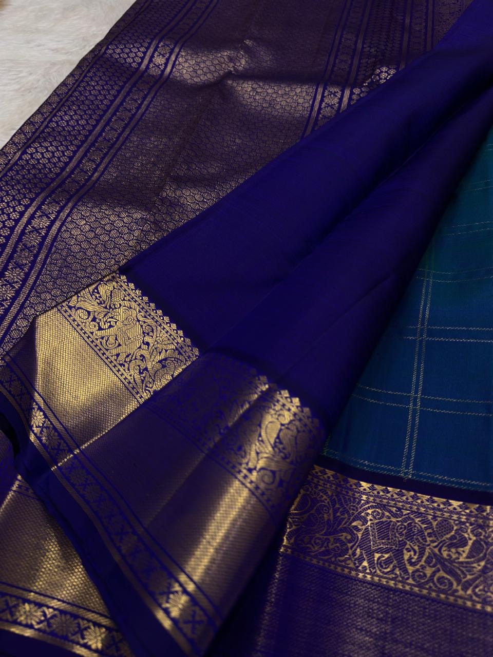 Antique gold zari detail on violet border of handwoven Kancheepuram saree — fine elephant and mango motifs woven in traditional Zari Kattam technique