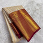 Full folded view of Kanchi Pattu Butta saree showing ivory ornate zari body and crimson peacock border contrast