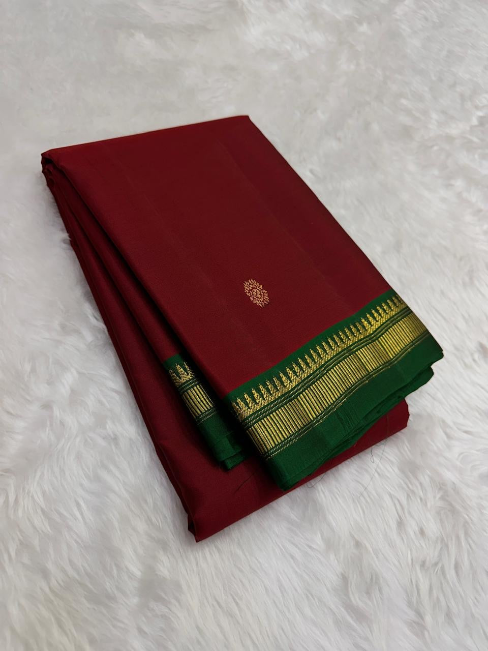 Pallu of the Kanjeevaram lightweight saree in bottle green with Pillayar Reku and Varisaipet gold zari bands