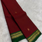 Folded view of the handwoven arakku red and bottle green Kanjeevaram lightweight Korvai silk saree