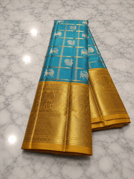 Handwoven pure silk Kanchi Pattu saree in turquoise blue with Zari Kattam body, Vanasringaram Butta in 3 gram gold zari, and wide Vanasringaram border — Idam Living