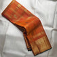 Full folded view of Kanchipuram Veldhari saree showing shot amber golden orange body and green selvedge