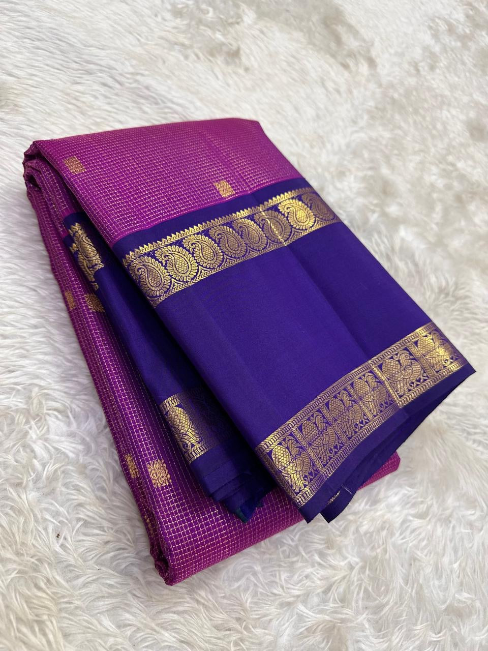 Close-up of magenta Zari Kattam silk body showing fine intersecting gold zari grid and scattered Maanga buttas on pure silk Kanchi Pattu saree