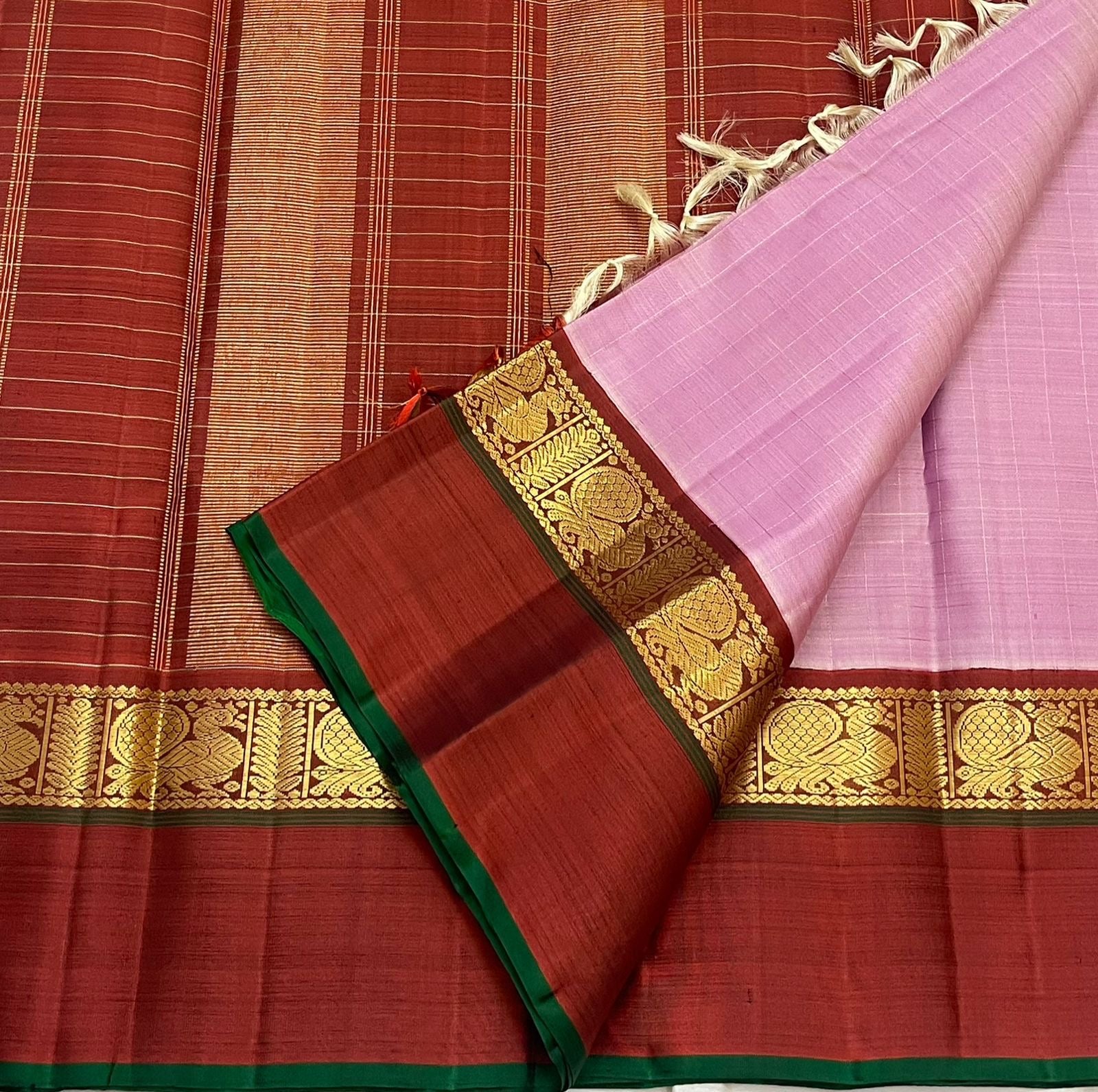 Deep maroon Korvai border with Kaal Irangiya gold zari motifs on mauve pink Kanjivaram silk saree