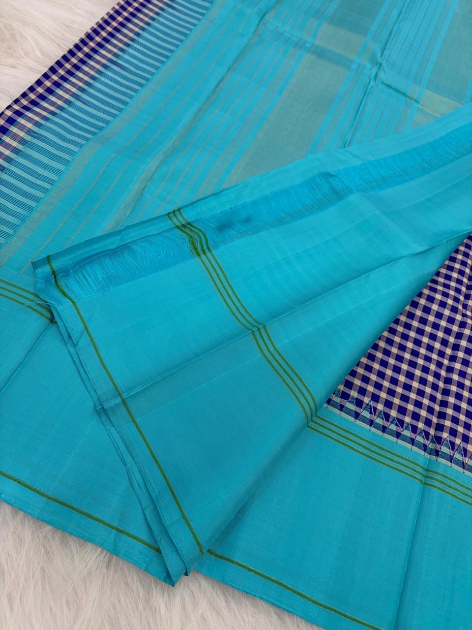 Navy blue and white handwoven pure silk Kanchi Pattu saree with Kanchi Kattam check body and sky blue border — full folded overview