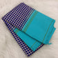 Pallu detail of navy blue and white pure silk Kanchi Pattu saree showing sky blue border with green silk stripe lines