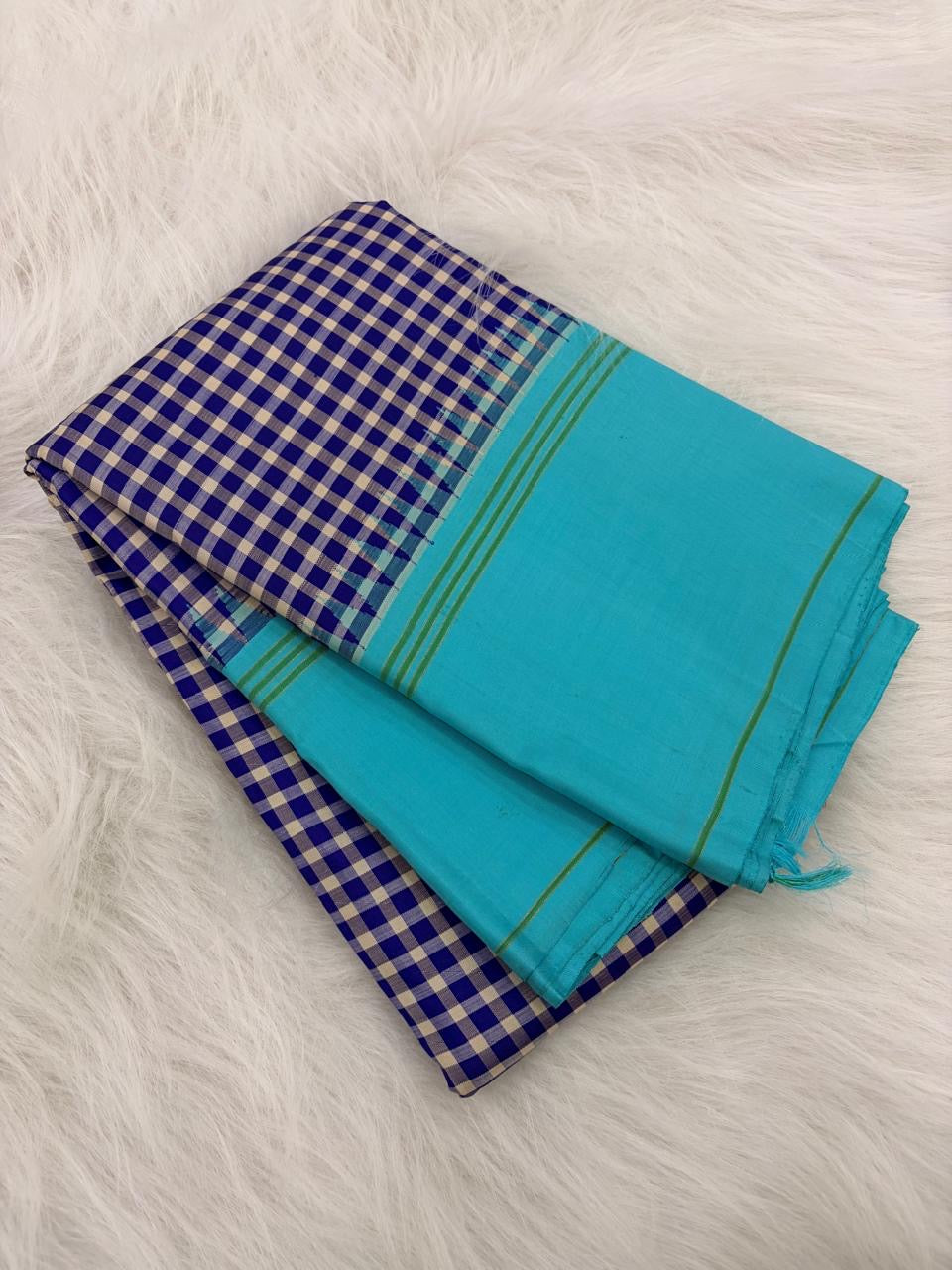 Pallu detail of navy blue and white pure silk Kanchi Pattu saree showing sky blue border with green silk stripe lines