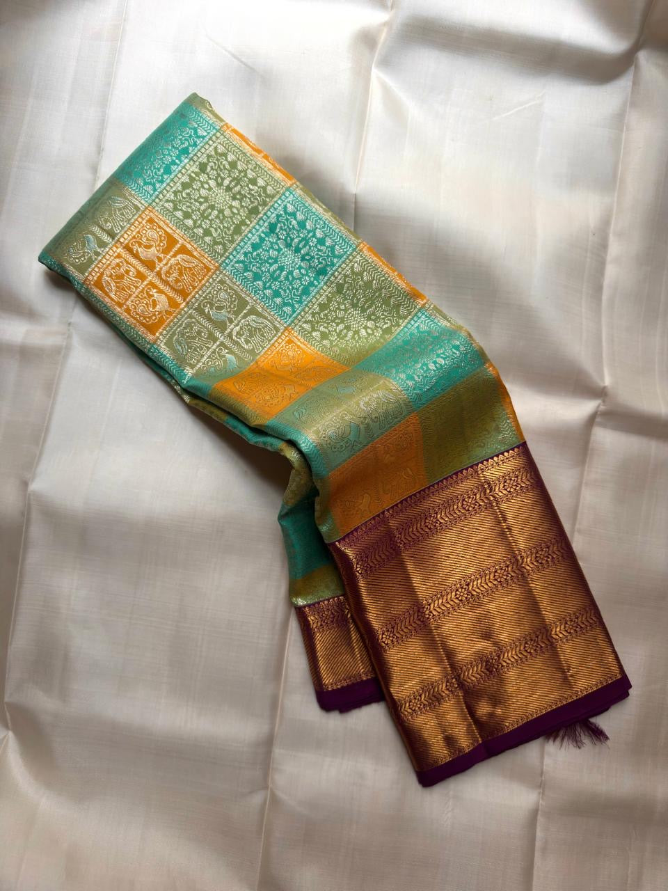 Close-up of turquoise silk Bomkai panel with elephant and animal figurals in antique gold and silver zari — KanchiPattu