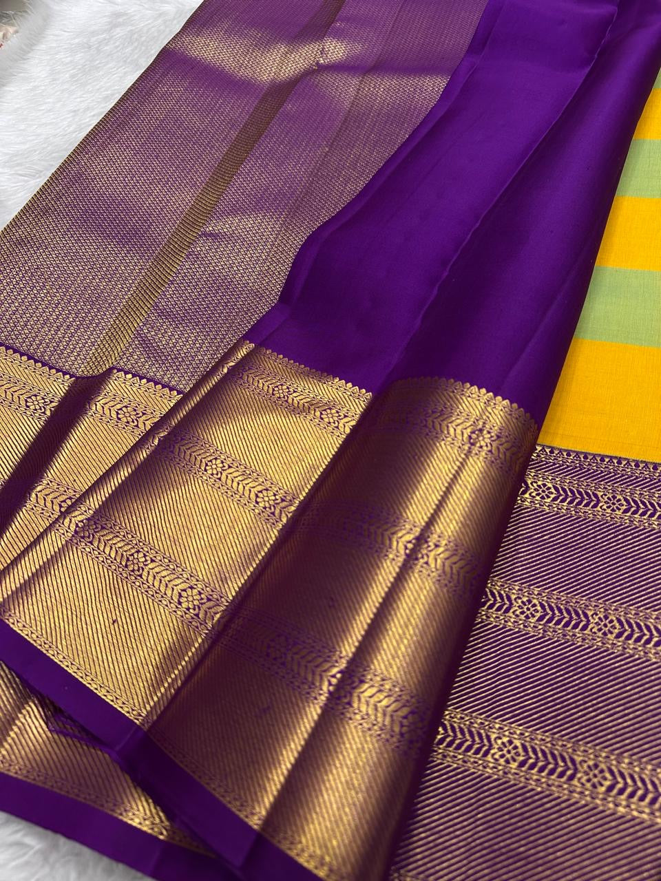 Full drape view of KanchiPattu Bomkai Butta saree with turquoise-saffron body and purple antique gold border