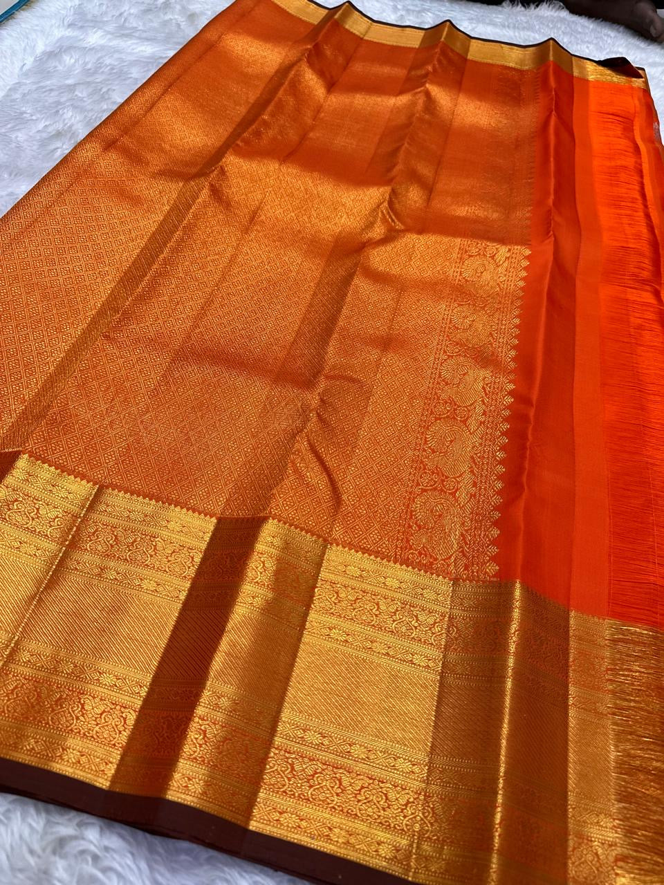 Handwoven Kanchi Pattu Veldhari saree in shot burnt orange with Zari Kattam grid, Yaanai Butta, and dark green antique gold border, full folded view