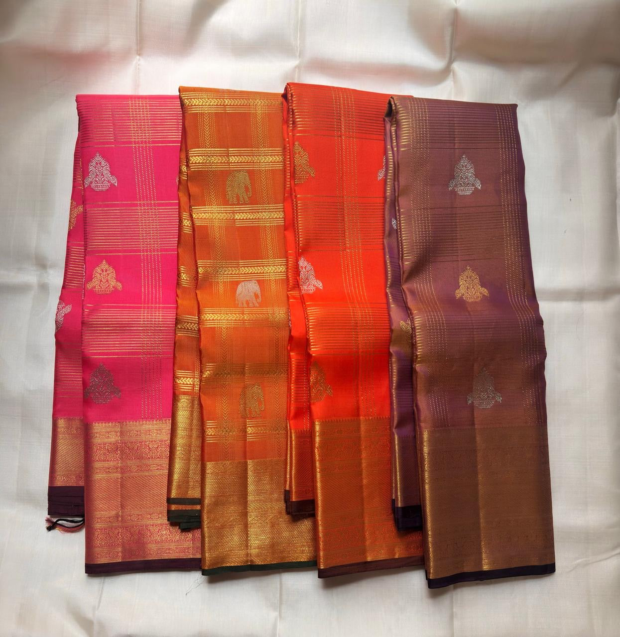 Antique gold geometric zari pallu on dark green ground — Kanchi Pattu Veldhari shot orange saree