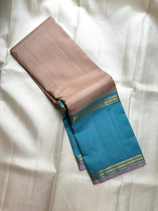 Close-up of warm taupe pure silk body on handwoven KanchiPattu saree — blush-beige plain weave with refined lustre