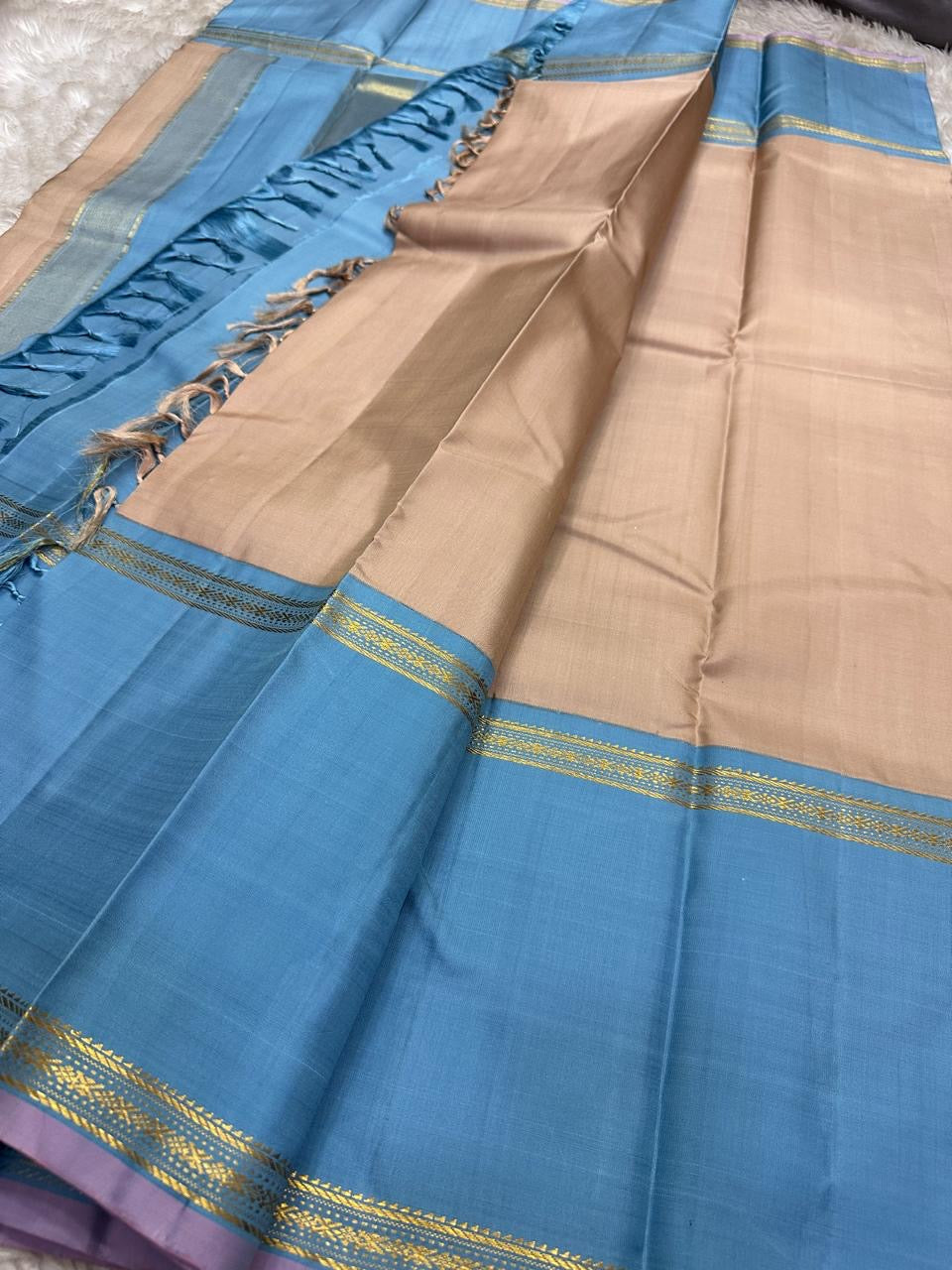 Pallu detail of taupe and cerulean blue pure silk KanchiPattu saree showing cerulean Korvai border with Thazhampoo Reku gold zari lines