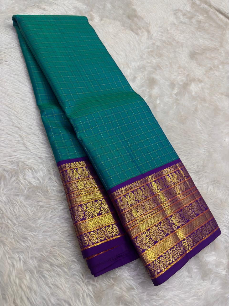 Deep violet Korvai Varisaipet border detail with antique gold zari peacock and floral motifs on handwoven KanchiPattu saree