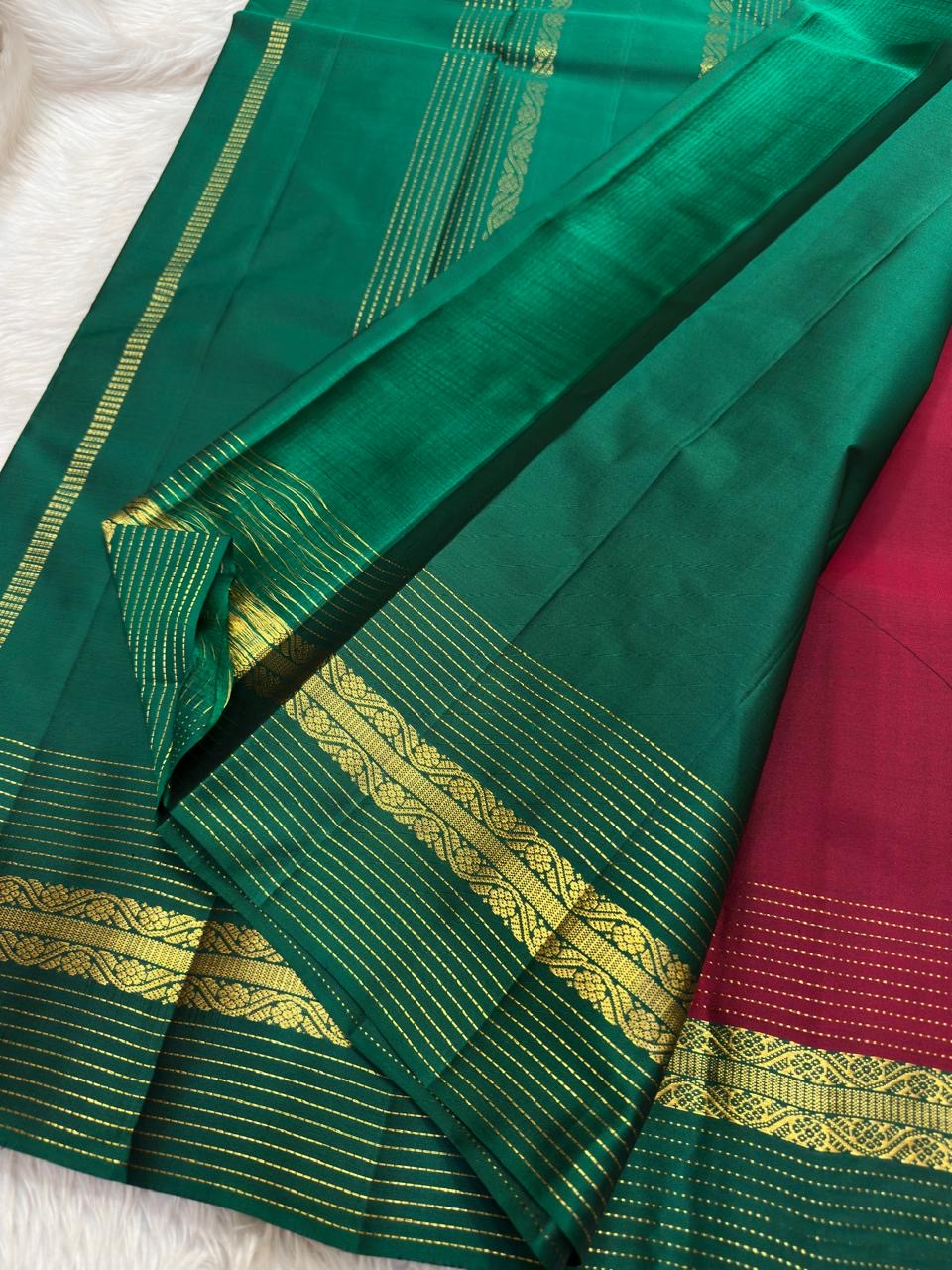 Bottle green Korvai border of the Kanjivaram lightweight saree with multicolour Varisaipet bands in gold, rust, and silk thread