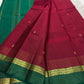 Close view of the deep rose silk body showing Kamalam Butta in gold zari and silk thread