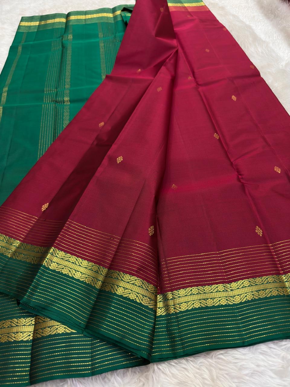 Close view of the deep rose silk body showing Kamalam Butta in gold zari and silk thread