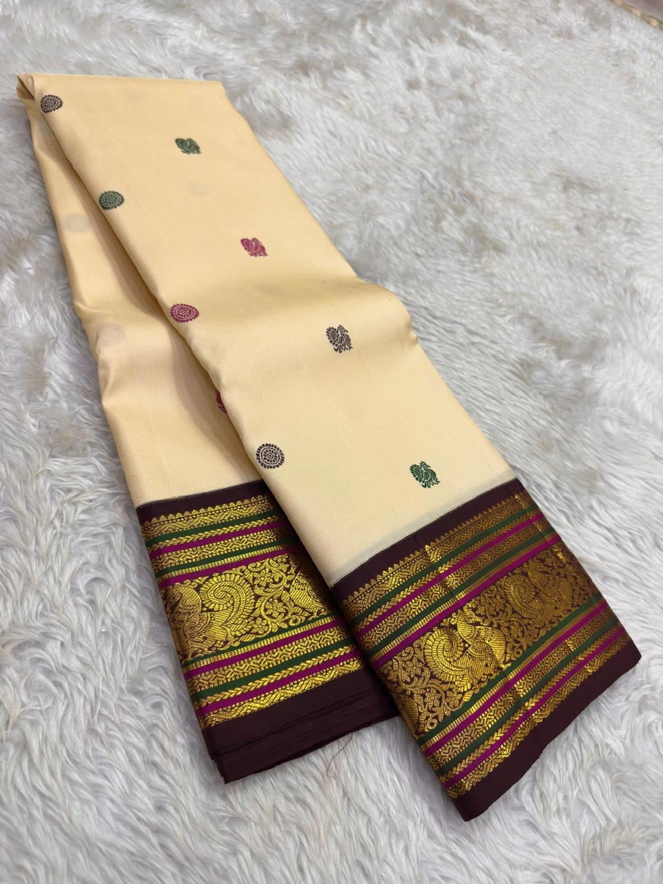 Arakku red Varisaipet border of the Kanchipuram saree with Yaanai elephant procession in gold zari and layered geometric bands