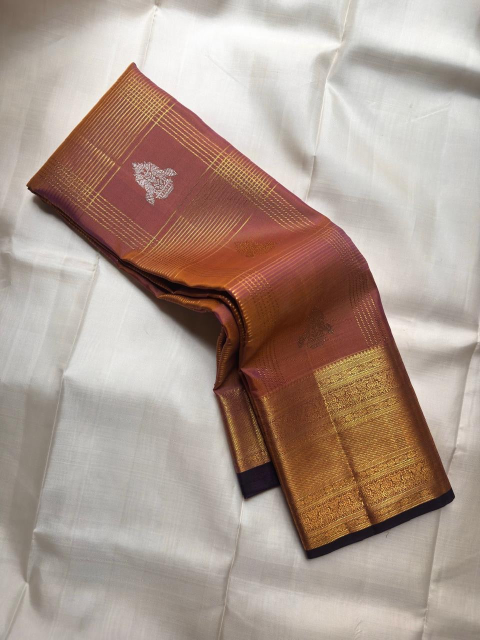 Close-up of shot copper-to-plum silk body with Zari Kattam gold grid and silver Gandaberunda Butta — Kanjipuram Veldhari