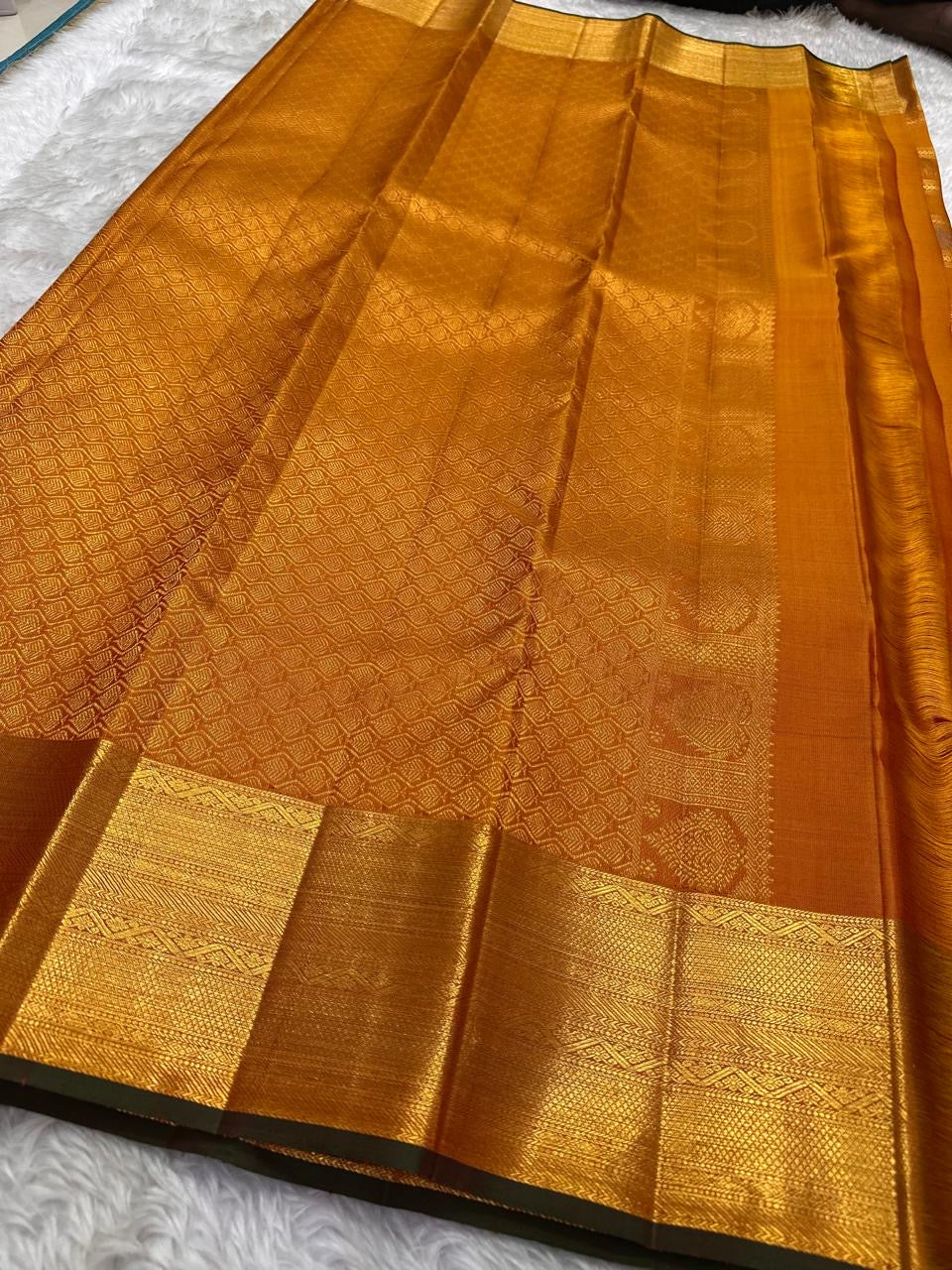 Handwoven Kanjipuram Veldhari saree in shot copper-plum with Zari Kattam grid, Gandaberunda Butta, and deep green antique gold border, full folded view
