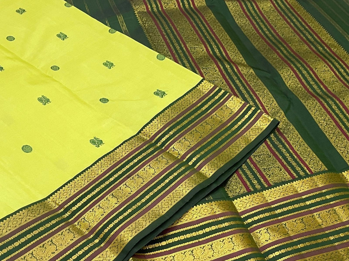 Handwoven Kanjeevaram Varisaipet saree in lime green with deep green Silk Thread Butta and dark green maroon multi-band gold zari border, full folded view